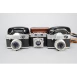 Two Kodak Instamatic Reflex SLR Cameras, with Schneider-Kreuznach 45mm f/2.8 lenses, shutters