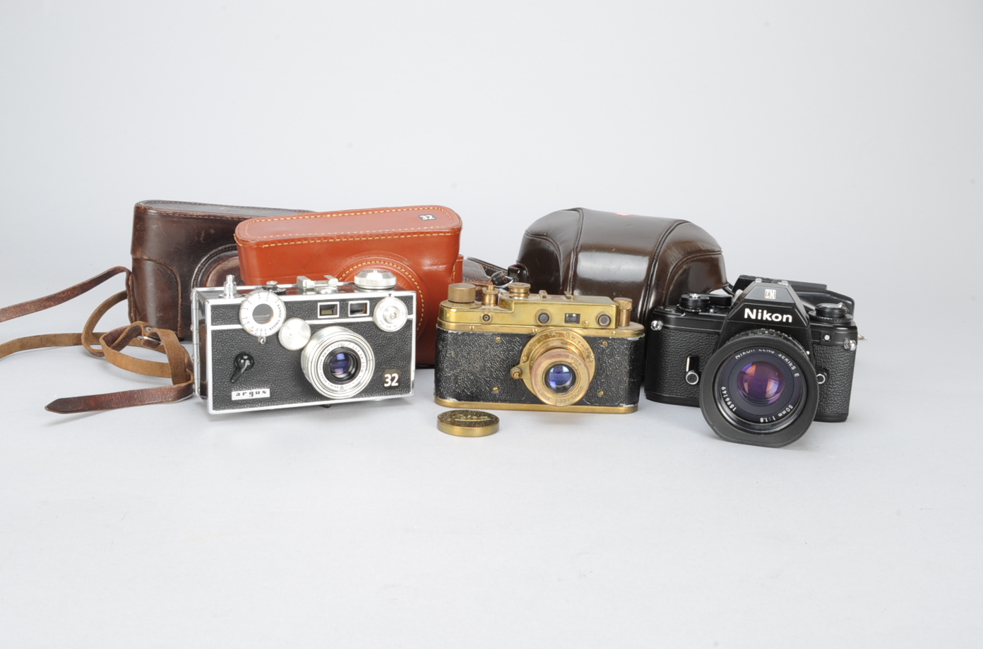 35mm Cameras, a Leica 2 brass coloured copy, Argus C3, Nikon EM with 50mm f/1.8 series E lens, lot