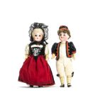 A Gerbruder Kuhnlenz boy and girl doll, with fixed dark eyes, the girl with blonde wig, the boy with