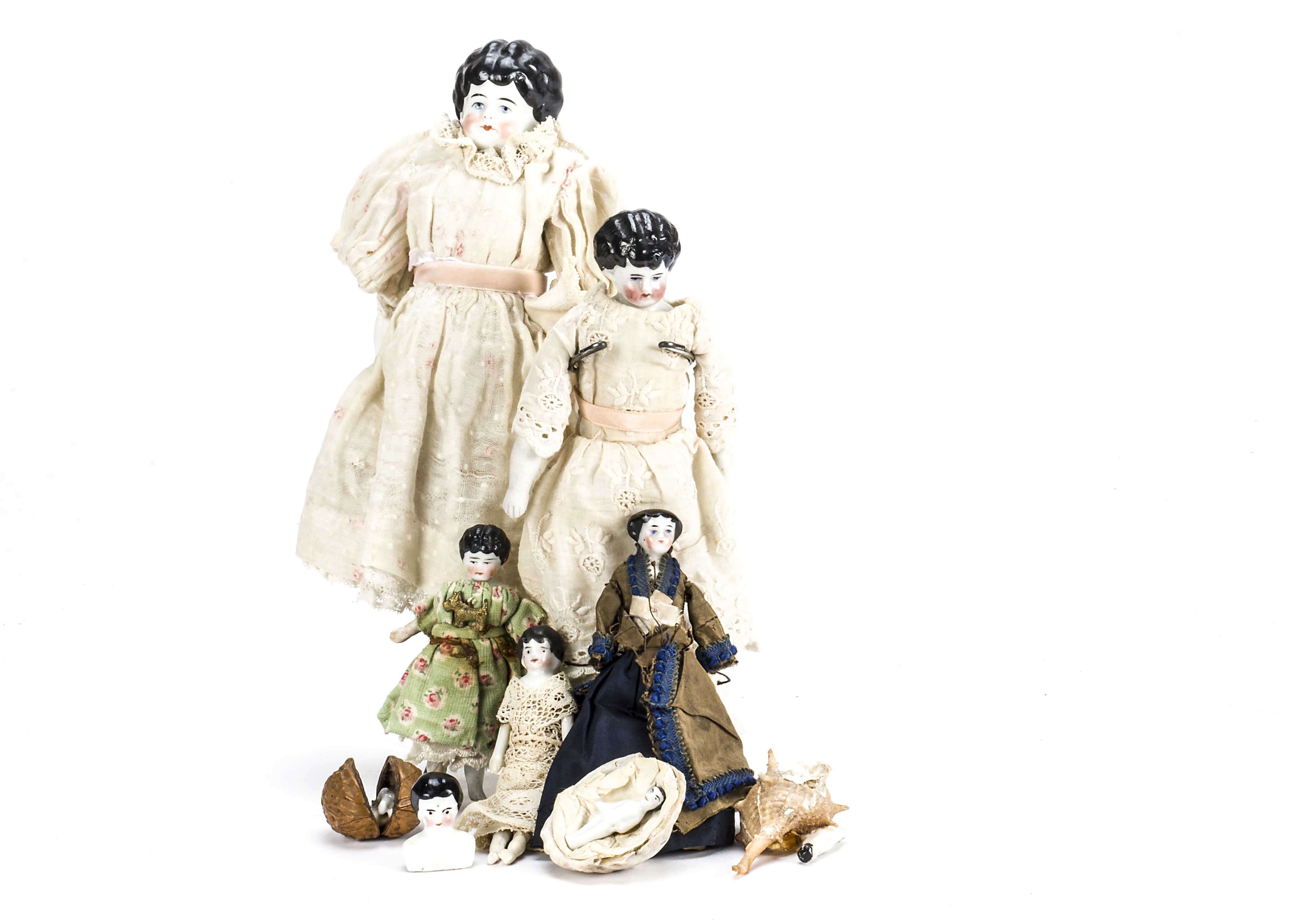 A china shoulder-head dolls’ house doll, With black moulded and painted hair, stuffed body with