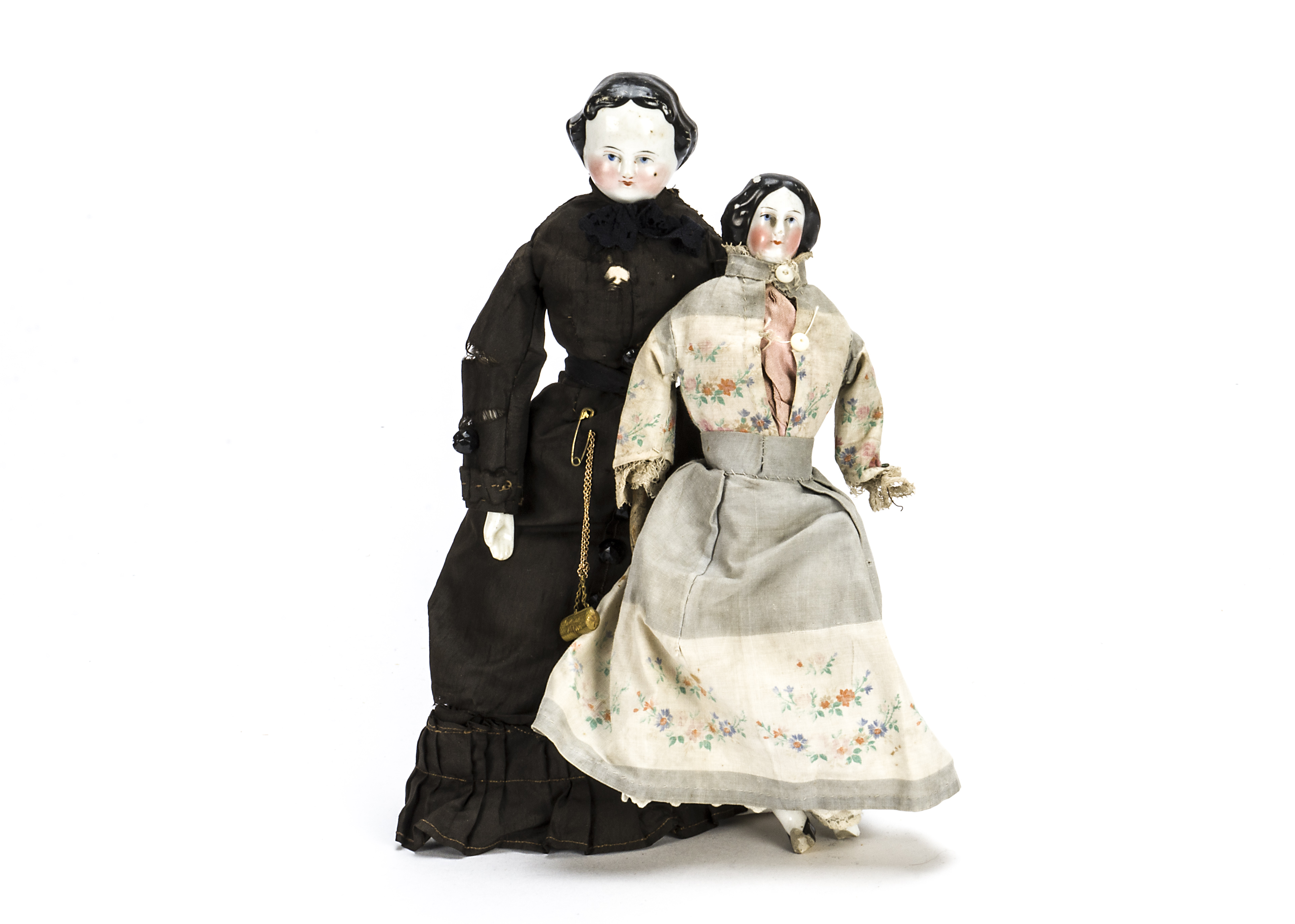A china shoulder-head doll, With black painted ringleted hair, stuffed body with china limbs,