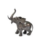 A bronze figure of an elephant, possibly Japanese, modelled in a standing position with its trunk