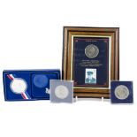 A group of commemorative coins, including a 1965 Winston Churchill crown, framed with a Churchill