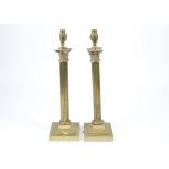 A pair of late Victorian brass lamp bases, shaped as Corinthian columns on stepped square bases,