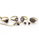 A collection of amethyst jewels, including four dress rings, a drop pendant with illusion set