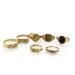 A collection of seven gold gentleman's rings, all 9ct gold, some set with cubic zirconia and onyx,