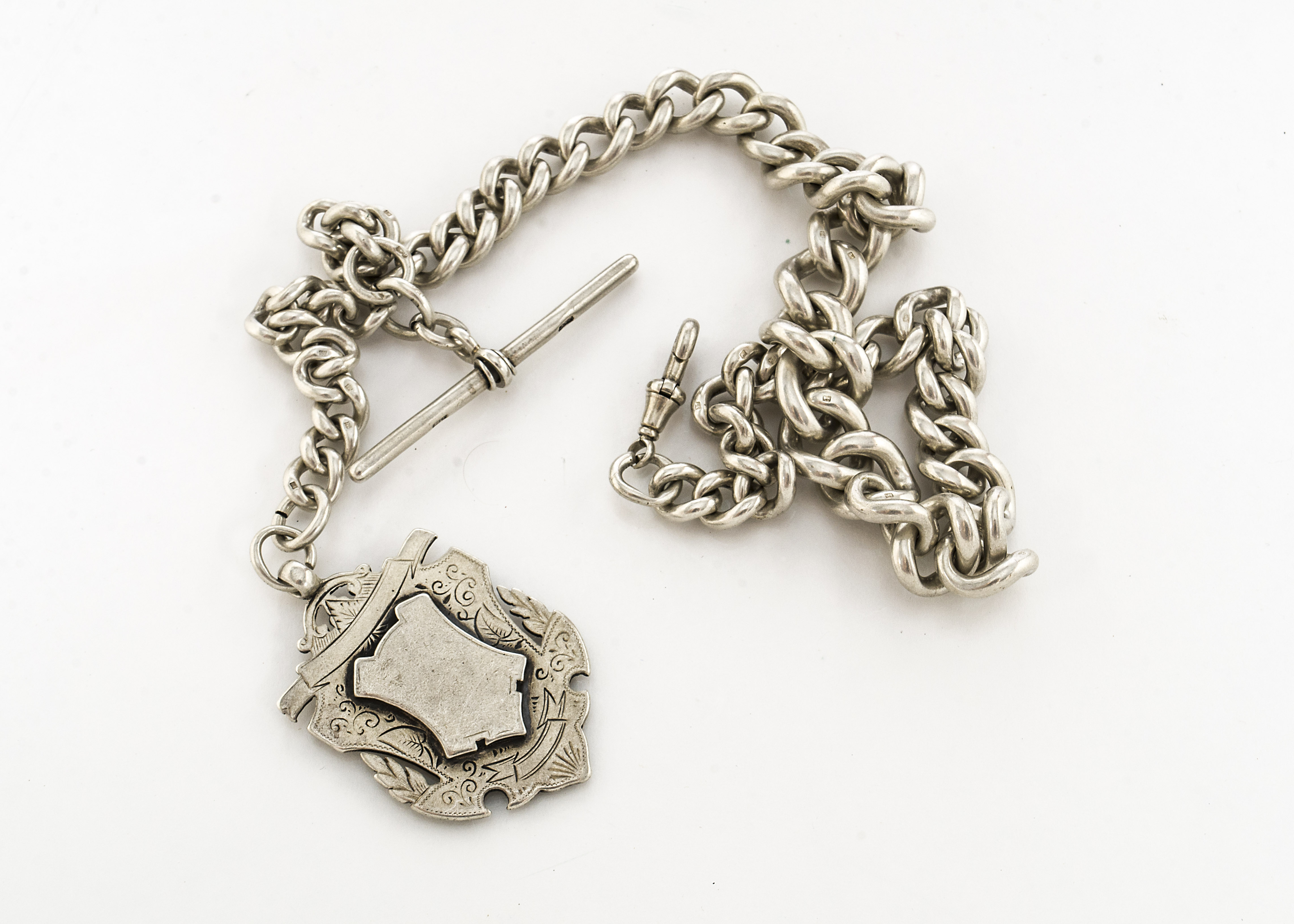 A late Victorian heavy silver watch chain, Birmingham 1890, graduating curb links with T bar and