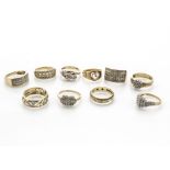 Ten 9ct gold diamond set dress rings, including a puzzle ring, a three stone illusion set crossover,