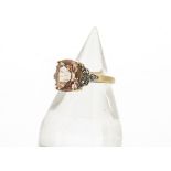 A 9ct gold morganite beryl and diamond dress ring, the oval mixed cut central stone in claw