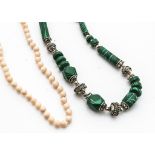 A graduated knotted, strung, coral bead necklace, 42cm long together with a malachite and silver