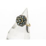 A 9ct gold topaz and diamond set dress ring, the flower setting with central circular cut topaz