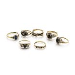 Seven 9ct sapphire set dress rings, some clusters, crossovers and dress rings, mostly set with small