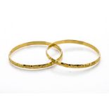 A pair of Indian yellow gold engine turned bangles, marked 916 to inner band, 6cm diameter, 34.8g