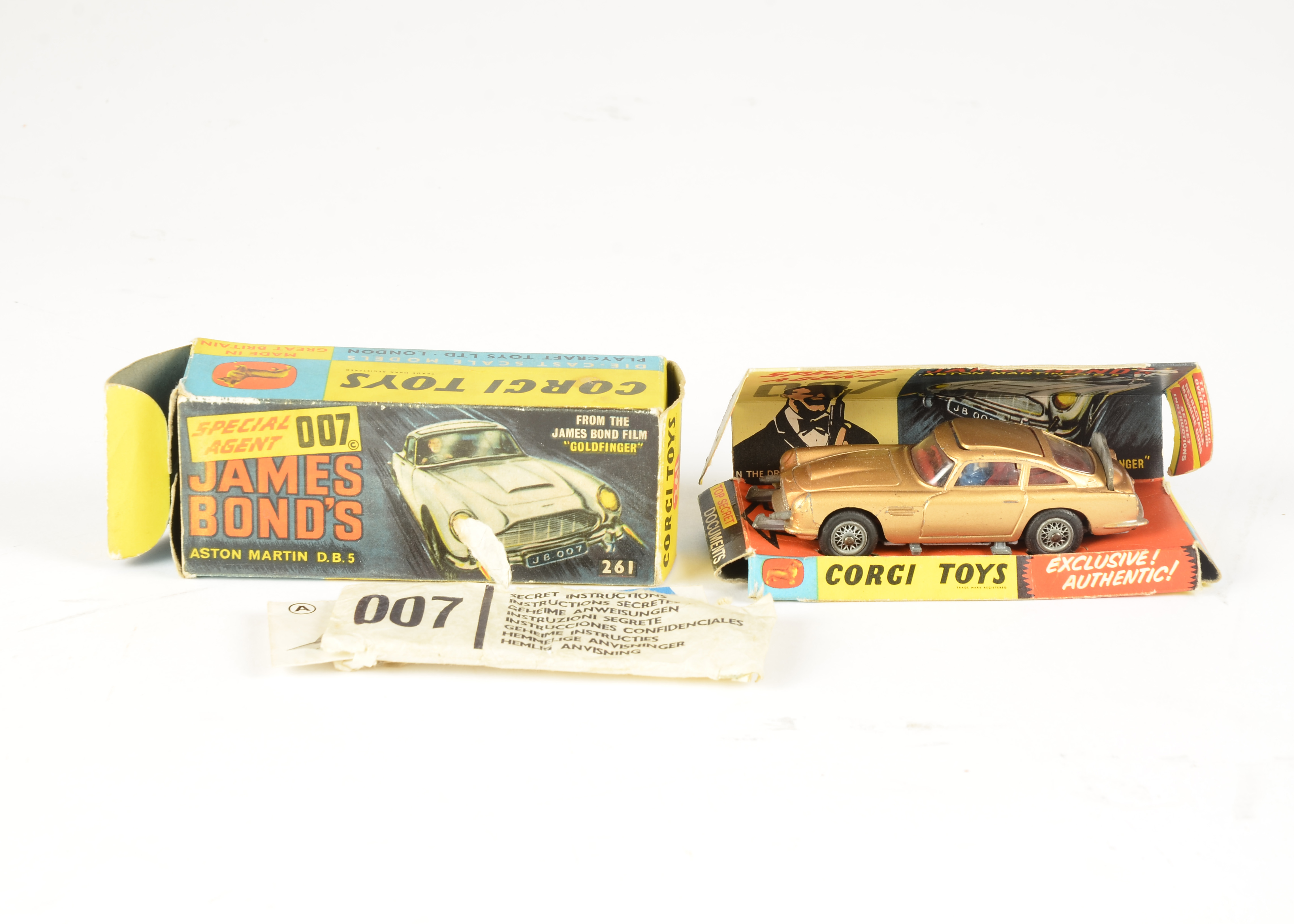 A Corgi Toys 261 James Bond Aston Martin, gold body, red interior, wire wheels, with bandit