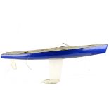 A large Pond Yacht with sails, constructed in fibre glass, blue hull and white deck with Aluminium