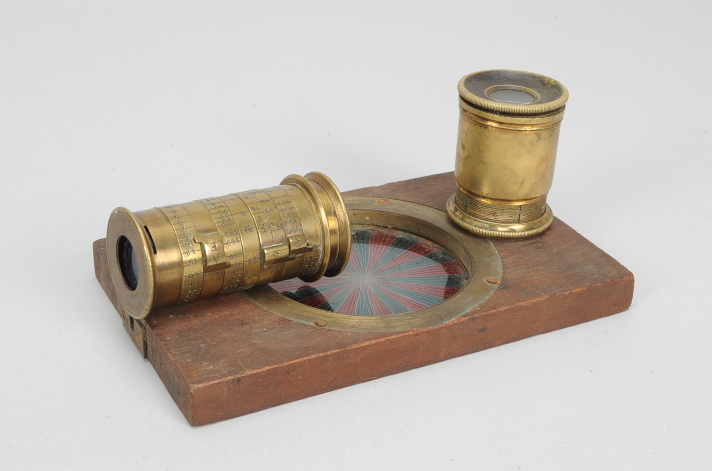 A Watkins brass Extinction Exposure Meter, incorporating focusing chain, with a Newton & Co