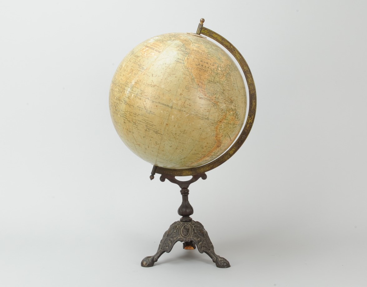 A Phillips' New Physical Terrestrial Globe, 14in diam., on decorative cast iron tripod stand,