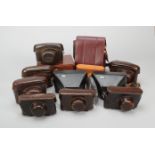 Leitz Camera Cases, seven camera cases, brown leather, with film reminder cut-outs, together with