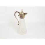 A silver mounted claret decanter, a diaper moulded claret decanter with floral chased silver top,