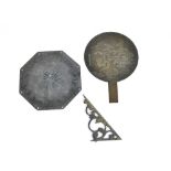 A brass sundial plate with Roman numerals, with a brass metalwork Oriental hand fan depicting cranes