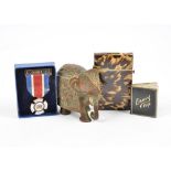 An Indian model of an elephant, steel with a copper finish, together with committee badge for the '