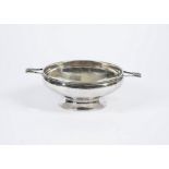 An arts and crafts style silver plated bowl, hammered structure with twin handles, unmarked,