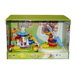 A Lego DUPLO Shop Display, featuring a hand operated Roundabout and Playground, in a green card/