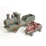 A pair of vintage pull along wooden Trains, both with spoked iron wheels, one painted green (