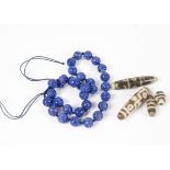 A Chinese lapis lazuli bead necklace, comprising thirty two circular carved beads of approximately