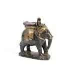 An Indian stone model of a man riding an elephant, decorated with gilt and red paint, height 16.5