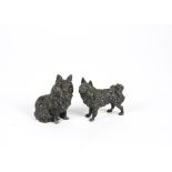 A pair of bronze dog figures, one standing the other seated, height 7 cm & 8 cm