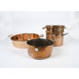 A large copper handled circular preserve pan, together with a large copper saucepan and another