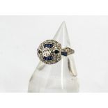 A Belle Epoque style diamond and sapphire dress ring, centred with old cut diamond with dragonfly