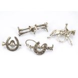 Four silver equestrian themed brooches, comprising three bar brooches decorated with riding crops,