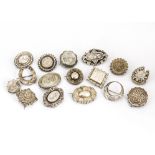 A collection of Victorian and Edwardian silver brooches, including roundels, crescent moons,