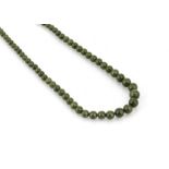 A nephrite string of graduated beads, with a gold barrel tongue and clasp, largest bead 8.1mm,
