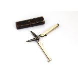 A pair of 19th Century folding scissors, presented in a maroon case, having ivory panels to
