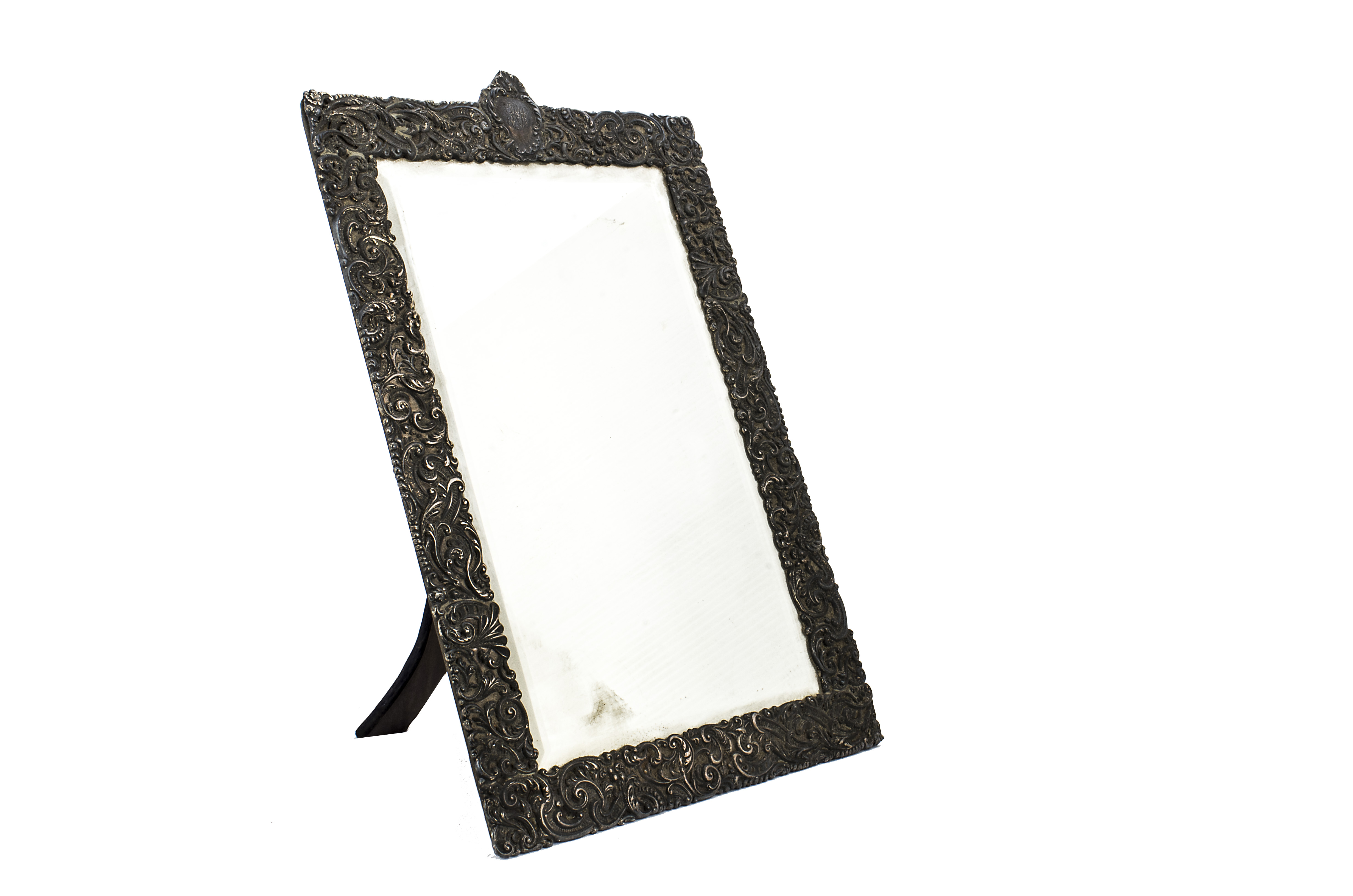 A Victorian silver table mirror, the ornate rococo themed frame, 51.5cm high, with bevelled glass