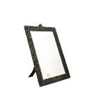 A Victorian silver table mirror, the ornate rococo themed frame, 51.5cm high, with bevelled glass