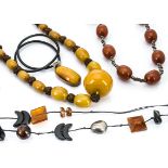 A Baltic amber and leather cord necklace, another amber and silver necklace, a large simulated amber