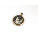 An early 19th Century gold on copper glazed circular pendant, with ivory miniature depicting