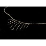 A diamond white gold set fringe necklace, the circular cut diamonds with claw set drops and a