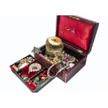 An early 20th Century red leather jewellery box, containing a quantity of costume jewellery