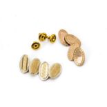 Two pairs of 9ct gold oval linked cufflinks, with engine turned decoration and a set of three gold