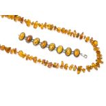 A Baltic amber rough bead, knotted strung necklace, with 14ct gold clasp, 51g together with an amber