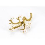 A continental, yellow metal and cultured pearl brooch, in the form of a textured branch set with