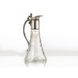 An early 20th Century silver plated and cut glass claret jug, tapered base with engraved floral