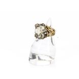 A modernist 9ct gold and rough quartz dress ring, the bark like shank with root styled claw and