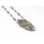 An arts and crafts white metal and opalescent bead necklace, the oval central panel with grape and