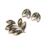 A Danish modernist brooch and earring set, By Raare & Krogh, of leaf design, the earrings with